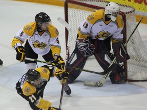 Sarnia Sting prospect, and 1st overall pick in the 2014 OHL Priority Selection, Jakob Chychrun (in white) sends Drew Morgan flying in front of the net during a scrimmage on day two of rookie camp on Sunday, June 8. The camp took place on Saturday and Sunday and was an opportunity for recent draft picks to meet and get acquainted with Sting staff. SHAUN BISSON/THE OBSERVER/QMI AGENCY