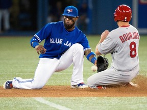 St. Louis Cardinals outfielder Peter Bourjos is tagged out by Toronto Blue Jays shortstop Jose Reyes at the Rogers Centre in Toronto, June 8, 2014. (NICK TURCHIARO/USA Today)