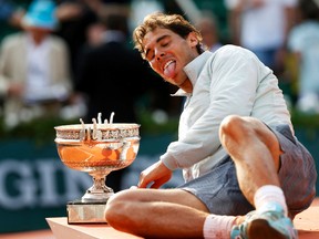 Rafael Nadal poses with the trophy after defeating Novak Djokovic to win the French Open in Paris, June 8, 2014. (VINCENT KESSLER/Reuters)