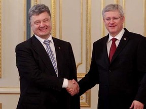 Ukraine's new president Petro z(L) shakes hands with Canada's Prime Minister Stephen Harper during their meeting in Kiev June 7, 2014.   REUTERS/Valentyn Ogirenko