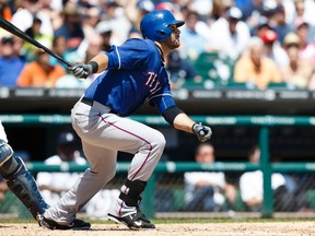 Texas Rangers first baseman Mitch Moreland hits an RBI single against the Detroit Tigers at Comerica Park in Detroit, May 25, 2014. (RICK OSENTOSKI/USA Today)