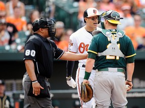 Baltimore Orioles third baseman Manny Machado argues with Oakland Athletics catcher Stephen Vogt at Camden Yards in Baltimore, June 8, 2014. (GREG FIUME/Getty Images/AFP)