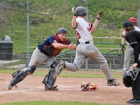 Kingston Ponies catcher Kurtis Miller tags out Nepean Cardinals' Brad McKay at the plate after McKay tried to score on a sacrifice fly during the top of the sixth in the first game of a double header at Megaffin Park on Sunday. Julia McKay/The Whig-Standard