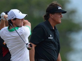 Phil Mickelson of the U.S. (right) and Rory McIlroy of Northern Ireland. (RUSSELL CHEYNE/Reuters)