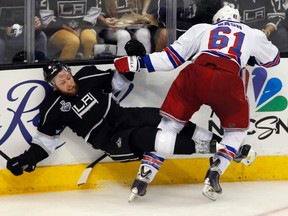Rangers forward Rick Nash hits defenceman Jake Muzzin of the Kings during Game 2 on Saturday night in Los Angeles. (Lucy Nicholson/Reuters)