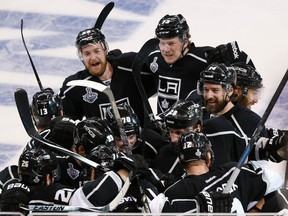 Los Angeles players celebrate their double-overtime victory against the Rangers on Saturday night. (Reuters)