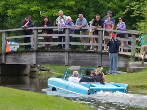 People watch from a bridge as Ken Alischer of Bayden, Ontario takes attendees for a spin at the 2014 Fleewood Country Cruize In at the Plunkett Estate in London, on Sunday.
CRAIG GLOVER/The London Free Press/QMI Agency