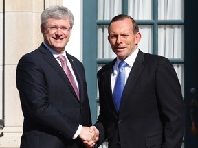 Canadian Prime Minister Stephen Harper, left, welcomes Australian Prime Minister Tony Abbott to 24 Sussex Drive, the Prime Minister's official residence, in Ottawa on June 9, 2014. (REUTERS/Patrick Doyle)