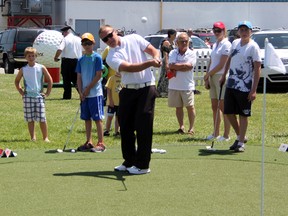 Sawmill golf apprentice Jesse Drydak (foreground) teaches a group of young golfers the basics of chipping at the CN/PGA of Canada Future Links display during Kids Funfest at Clearwater Arena on Saturday, June 7. PGA of Canada president Doug Alexander and CN assistant superintendent Jeffrey Wood were on hand to announce Future Links' new Golf in Schools initiative. SHAUN BISSON/THE OBSERVER/QMI AGENCY
