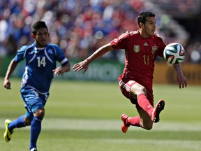 Spain's Pedro Rodriguez moves past El Salvador's Andre Flores during the first half of their friendly soccer match in Landover, Maryland June 7, 2014. (REUTERS/Gary Cameron)