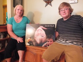 Carol Butt sits beside her son Jordan. A picture of her other son Jacob sits between them. Jacob died in 2012 while playing the choking game and now his mother aims to educate others about the dangers. BRENT BOLES / THE OBSERVER / QMI AGENCY.