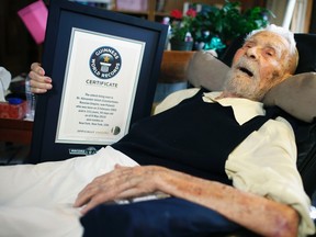 Alexander Imich, 111, holds a Guinness World Records certificate recognizing him as the world's oldest living man during an interview with Reuters at his home on New York City's upper west side in this May 9, 2014 file photo. (REUTERS/Mike Segar/Files)