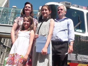 Eleven-year-old Kate Chacksfield (second from right) with her mom Carolyn, sister Emma, 8, and dad David after receiving a 911 award at City Hall on Monday, June 9, 2014. (JON WILLING Ottawa Sun)