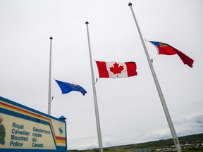 Flags fly at half-mast outside the Peace Regional RCMP detachment in peace River Alberta onSunday June 8, 2014 in honour of the three mounties who were killed in Moncton. "Our thoughts are with our colleagues in New Brunswick during this difficult and tragic time" said Deputy Commissioner, Marianne Ryan, Commanding Officer of the Alberta RCMP said in a statement released June 5. The town of Peace River has also lowered its flags to half-mast and will keep them there until the funerals for the officers.  ADAM DIETRICH/RECORD-GAZETTE/QMI AGENCY