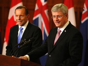 Prime Minister Stephen Harper (R) and his Australian counterpart Tony Abbott hold a joint news conference after a meeting on Parliament Hill in Ottawa June 9, 2014. REUTERS/Patrick Doyle