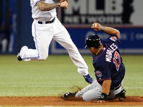 Toronto Blue Jays second baseman Brett Lawrie throws to first base for a double play against the Minnesota Twins at the Rogers Centre in Toronto, June 9, 2014. (DAN HAMILTON/USA Today)
