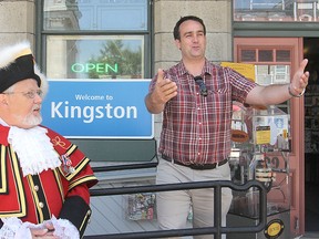 Mayor Mark Gerretsen, right, welcomes visitors to Kingston with town crier Chris Whyman as they helped kick off Tourism Awareness Week in the city during a ceremony Monday morning. MICHAEL LEA\THE WHIG-STANDARD