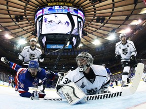 Los Angeles Kings goalie Jonathan Quick and New York Rangers left wing Chris Kreider look back for the puck as they collide during Game 3 of the Stanley Cup final at Madison Square Garden in New York, June 9, 2014. (BRUCE BENNETT/Pool/USA Today)