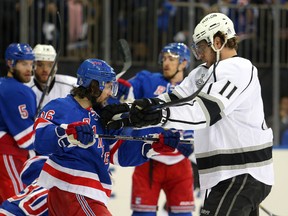 Kings centre Anze Kopitar (right) shoves Rangers winger Mats Zuccarello (36) on Monday night during Game 3 of their series. (USA TODAY/PHOTO)