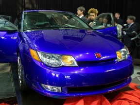 Members of the press view the new 2003 Saturn ION quad coup at its 
debut at the New York International Auto Show in New York in this file photo taken March 27, 2002.  REUTERS/Peter Morgan/Files