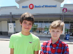 Caleb Turon (left) and Matthew Hewlett hacked a Bank of Montreal ATM, they alerted bank staff to the vulnerability of the ATM.  The 14 year olds were late returning to school from lunch, but had a note from the bank indicating they were helping with security.  Tuesday, June 4, 2014.   Chris Procaylo/Winnipeg Sun/QMI Agency