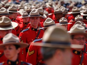 Royal Canadian Mounted Police officers gather Tuesday to attend the funeral for three fellow officers who were killed last week in Moncton. (REUTERS)