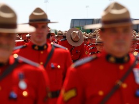 Royal Canadian Mounted Police officers gather to attend the funeral for three fellow officers who were killed last week in Moncton, New Brunswick, June 10, 2014.

REUTERS/Mark Blinch