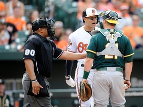 Orioles batter Manny Machado argues with Athletics catcher Stephen Vogt during eighth inning MLB action in Baltimore on Sunday, June 8, 2014. Machado was suspended five games Tuesday for throwing his bat. (Greg Fiume/Getty Images/AFP)