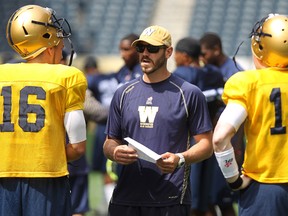 Robert Marve (left) chats with Bombers assistant coach Buck Pierce during training camp. Marve had a solid debut in the Bombers exhibition loss to the Argos on Monday.