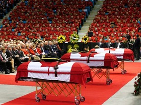 The caskets of three Royal Canadian Mounted Police officers who were killed last week are pictured during a regimental funeral in Moncton, New Brunswick, June 10, 2014. Justin Bourque, 24, was charged with murder on Friday in the slayings of the three Royal Canadian Mounted Police officers, Constables Fabrice Georges Gevaudan, 45; David Joseph Ross, 32, and Douglas James Larche, 40, during a shooting spree in the eastern Canadian city of Moncton. The shooting spree was one of the worst of its kind in Canada, where gun laws are stricter than in the United States and deadly attacks on police are rare.     REUTERS/Mark Blinch