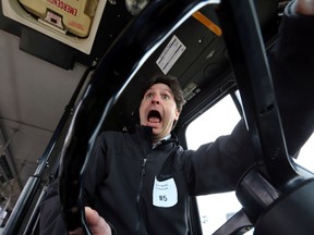 Sun reporter Dave Lazzarino tries his hand at driving a bus in the Bus Rodeo course at Northlands Park in Edmonton, Alta., on Monday, June 10, 2014.  Lazzarino did well and only knock down a few barrels.  Perry Mah/Edmonton Sun