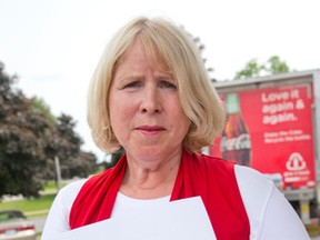 Liberal London North Centre candidate Deb Matthews holds a letter she alleges was sent to Liberal supporters in her riding by a local Conservative, pointing the voters to the wrong polling station, before a stop by PC leader Tim Hudak in London, Ontario on Tuesday June 10, 2014. (CRAIG GLOVER, The London Free Press)