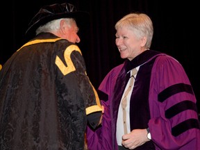 Sheila Fraser accepts an honorary doctor of laws degree from Western University?s chancellor emeritus John Thompson, during convocation ceremonies at Alumni Hall in London this week. Fraser, Canada?s first female auditor general, is famed for her report 10 years ago revealing the federal sponsorship scandal. (DEREK RUTTAN, The London Free Press)