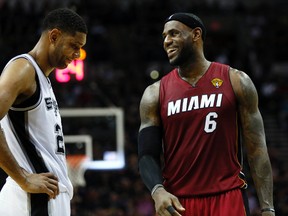 Heat forward LeBron James (right) has a laugh with Spurs forward Tim Duncan during the NBA Finals. (Soobum Im/USA TODAY Sports)