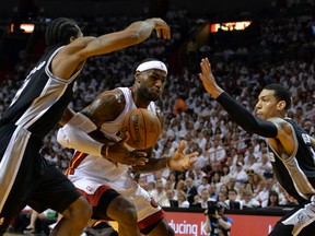 Miami Heat forward LeBron James (centre) drives between San Antonio Spurs guard Danny Green (right) and forward Kawhi Leonard (left) during the first half of Game 3 of the NBA Finals on Tuesday night. (Steve Mitchell/USA TODAY Sports)