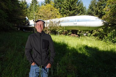 Bruce Campbell stands near his Boeing 727 home in the woods outside the suburbs of Portland, Oregon May 21, 2014. In 1999, the former electrical engineer had a vision: To save retired jetliners from becoming scrap metal by reusing them. Campbell, 64, is one of a small number of people worldwide who have transformed retired aircraft into a living space or other creative project, although a spokesman for the Aircraft Fleet Recycling Association was unable to say precisely how many planes are re-used this way. Picture taken May 21.  REUTERS/Steve Dipaola