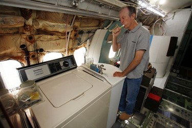 Bruce Campbell brushes his teeth at a sink in his Boeing 727 home in the woods outside the suburbs of Portland, Oregon May 21, 2014. In 1999, the former electrical engineer had a vision: To save retired jetliners from becoming scrap metal by reusing them. Campbell, 64, is one of a small number of people worldwide who have transformed retired aircraft into a living space or other creative project, although a spokesman for the Aircraft Fleet Recycling Association was unable to say precisely how many planes are re-used this way. Picture taken May 21.  REUTERS/Steve Dipaola
