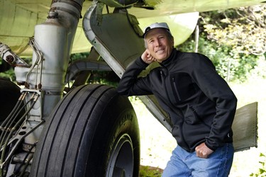 Bruce Campbell leans on a tyre of his Boeing 727 home in the woods outside the suburbs of Portland, Oregon May 21, 2014. In 1999, the former electrical engineer had a vision: To save retired jetliners from becoming scrap metal by reusing them. Campbell, 64, is one of a small number of people worldwide who have transformed retired aircraft into a living space or other creative project, although a spokesman for the Aircraft Fleet Recycling Association was unable to say precisely how many planes are re-used this way. Picture taken May 21.  REUTERS/Steve Dipaola