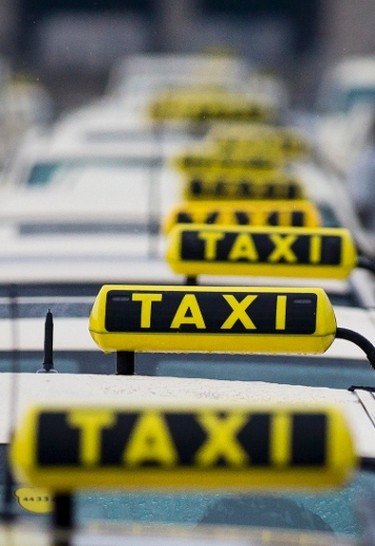 Taxis are lined-up in front of the Olympic Stadium in Berlin during a Europe-wide protest of licensed taxi drivers, against taxi hailing apps that are feared to flush unregulated private drivers into the market, June 11, 2014. REUTERS/Thomas Peter
