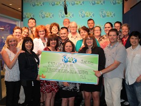 A group of 26 present and former Canada Revenue Agency workers from Ottawa celebrate their big Lotto Max win. (Submitted image)