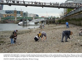 Amateur sleuths look for artifacts on the rocky foreshore of the River Thames at low tide during a walk led by Dr. Fiona Haughey, an expert on intertidal Thames history. Items not of significant value may be kept by their finders. JOHN KEYES/MERIDIAN WRITERS' GROUP