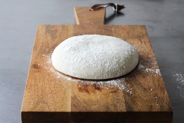 Pizza DoughStart with the dough, enough for one 12-to 14-inch (30 to 35 cm) pizza, either a stone or pan. It takes barely seconds in a food processor, or just minutes, by hand. Double the recipe for two pizzas.Ingredients:1 1/2 cups (375 ml) all-purpose flour1 tsp. (5 ml) quick-rising yeast
1/2 tsp. (2 ml) salt1/2 cup (125 ml) water1/2 tsp. (2 ml) salt2 tsp. (10 ml) olive oil1 to 2 Tbsp. (15 to 30 ml) cornmealDirections:In food processor, whirl flour, yeast and salt until blended. Heat water and oil until hot to touch. With motor running, pour over dry ingredients. Whirl until dough forms and starts to collect in a ball, about 1 minute. Collect dough into ball; place in lightly oiled bowl, turning to coat dough all over. Cover and let rise in a warm spot until double in bulk, about 1 hour.Press down dough; cover and let rest for 5 minutes before rolling into 12-to 14-inch (30 to 35 cm) circle. If at any time dough becomes too elastic to roll, cover with a damp clean tea towel and let rest for 5 minutes.Sprinkle pizza stone or pan with enough cornmeal to cover; roll dough loosely around rolling pin and unroll over the stone or pan. Readjust pizza shape to round and evenly thick. Let rest for 5 minutes before adding toppings.YIELD: Makes 1 pizza crust, 12-to 14-inches in diameter.HANDMADE PIZZA DOUGH: In large bowl, whisk flour, yeast and salt until blended. Pour in heated water and oil; stir until dough forms, adding a few dribbles more water if needed. Gather into ball; on lightly floured surface, knead until elastic and smooth, about 8 minutes. Let rise and roll as above.(Courtesy of Kitchenkonfidence.com)