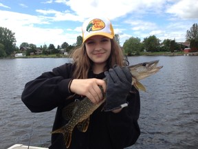 Camryn Heidman shows a typical northern pike from Whitewater Lake.