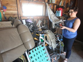 West Kildonan resident Julie Horbal examines the damage to her garage after it was vandalized by a raccoon. (Brian Donogh/Winnipeg Sun)