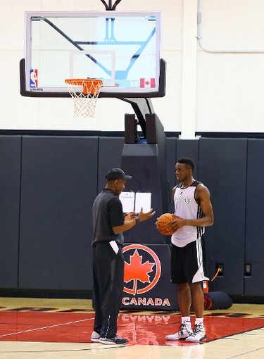 Head coach Dwane Casey has a word with prospect Jemari Grant during a Raptors pre-draft workout camp at the Air Canada Centre in Toronto on Wednesday. (DAVE ABEL/Toronto Sun)