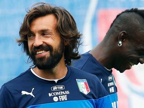 Italy's Andrea Pirlo (left) and Mario Balotelli smile during training ahead of the World Cup at the Portobello training center in Mangaratiba, June 11, 2014. (ALESSANDRO GAROFALO/Reuters)