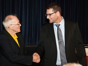 Joe Drago coach of the year award winner Reg Bonin, right,  is congradulated by fellow nominee Len Thompson at the House of Kin 46th annual sports celebrity dinner.