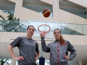 National team twin-members Katherine and Michelle (r) Plouffe pose for a photo.  The Canadian women's basketball team was introduced at city hall in Edmonton, Alta., on Monday, June 10, 2014.   (Perry Mah/Edmonton Sun)
