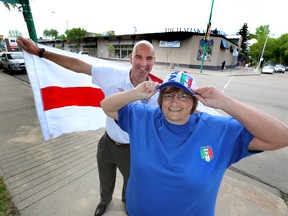 Italian Centre Shop owner Teresa Spinelli and Edmonton Sun’s Circulation Director Nigel Wainwright show off their World Cup colours on Wednesday. The Italian Centre Shop and the Sun are co-hosting a live broadcast of the Italy/England game on a big screen in Caboto Park. (Perry Mah/Edmonton Sun)