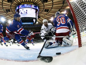 New York Rangers defenceman Anton Stralman clears the puck off the goal line away from Los Angeles Kings centre Jeff Carter during Game 4 of the Stanley Cup final at Madison Square Garden in New York, June 11, 2014. (BRUCE BENNETT/Pool/USA Today)